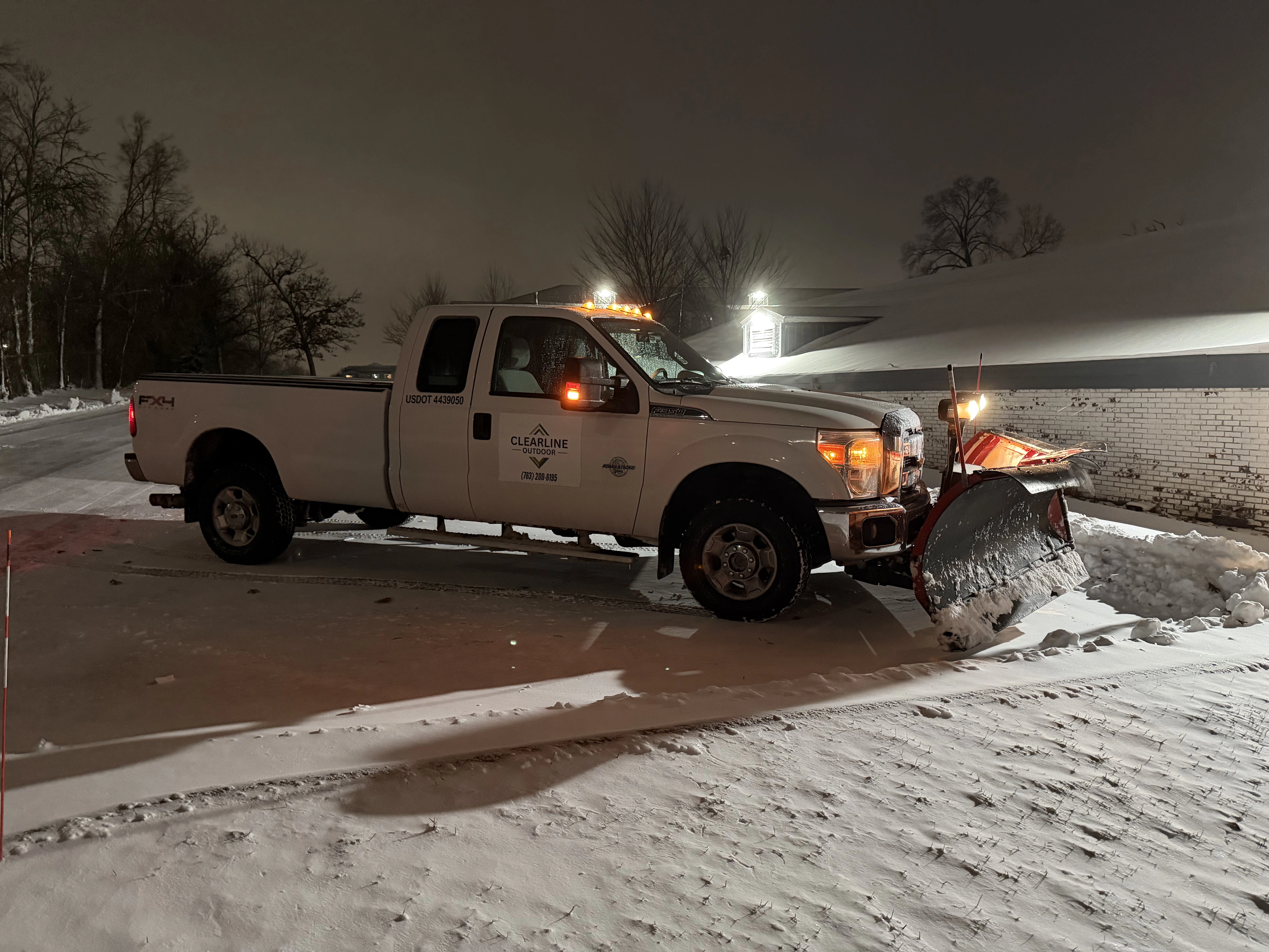 Clearline Outdoor snow plow truck staged on a North Metro commercial property