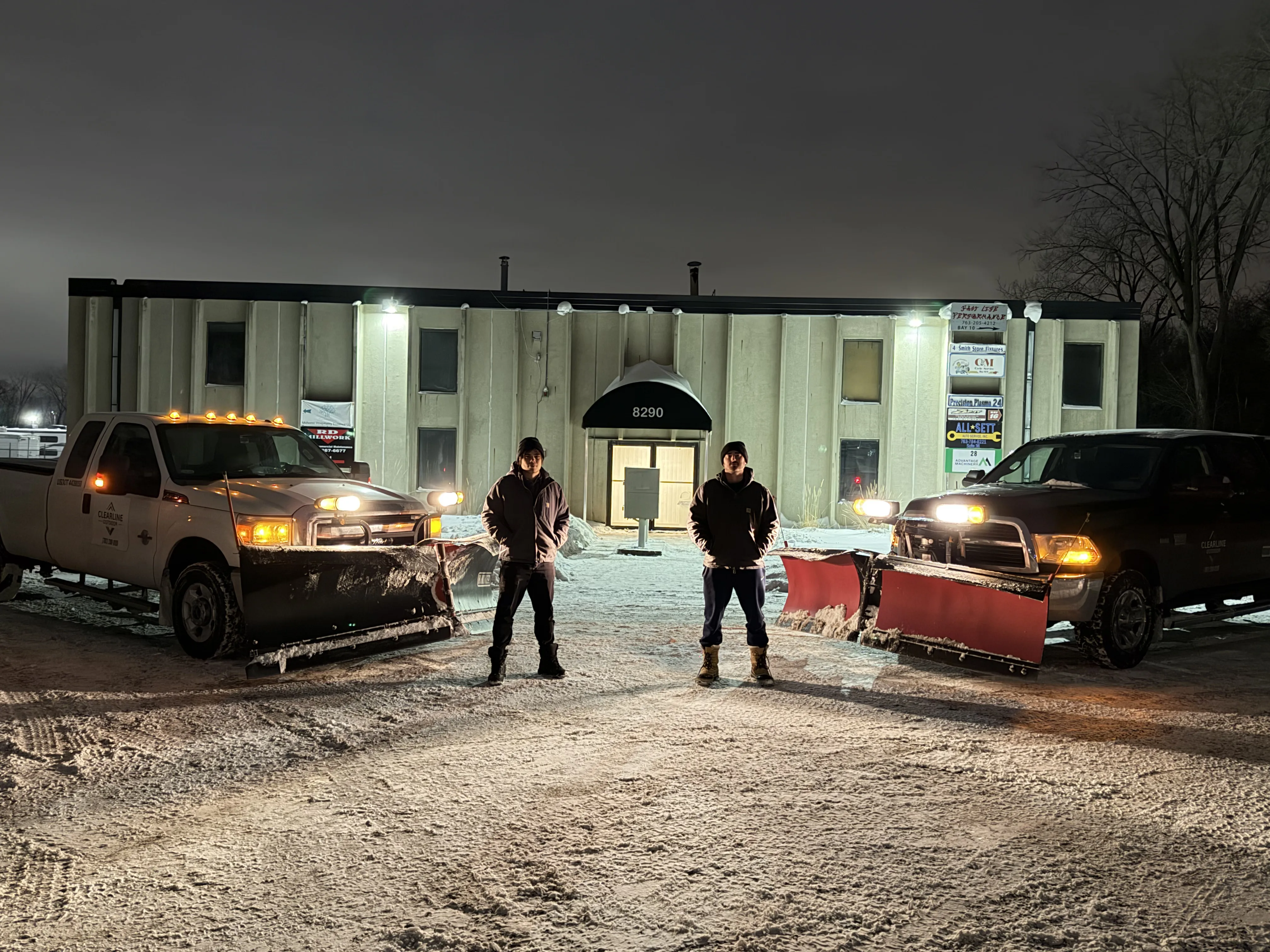 Clearline Outdoor founders Carsten and Brock at their warehouse with snow plow trucks