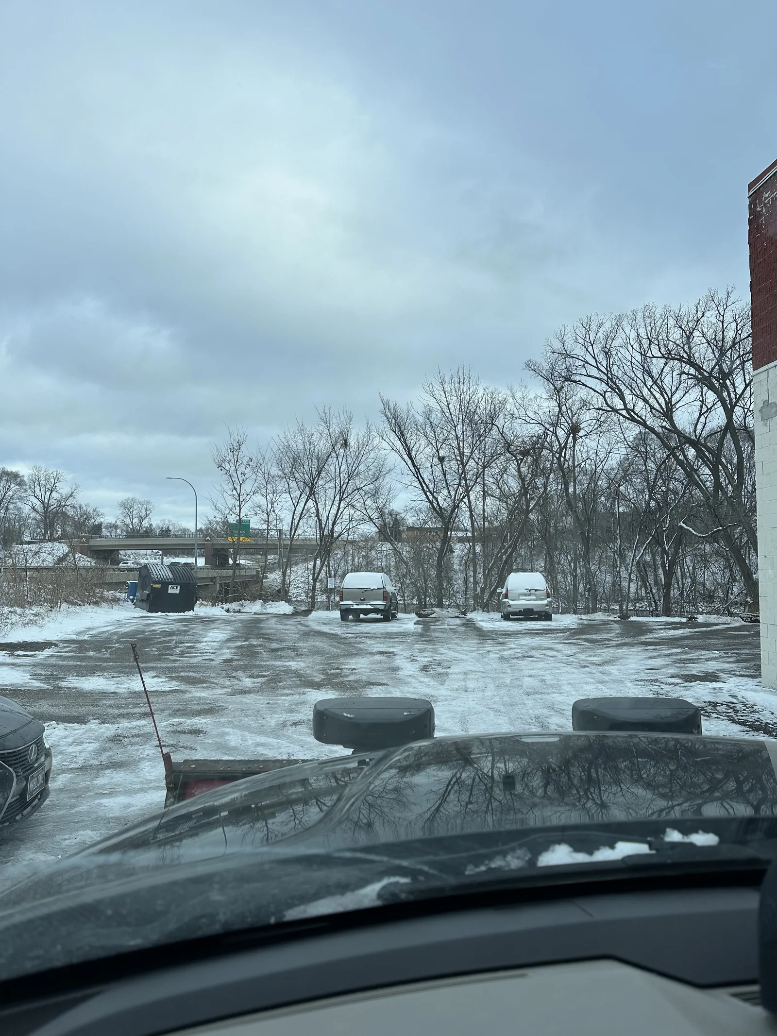 Cleared parking lot with visible plow tracks at Maple Ln Apartments in Anoka, Minnesota after a snow removal visit