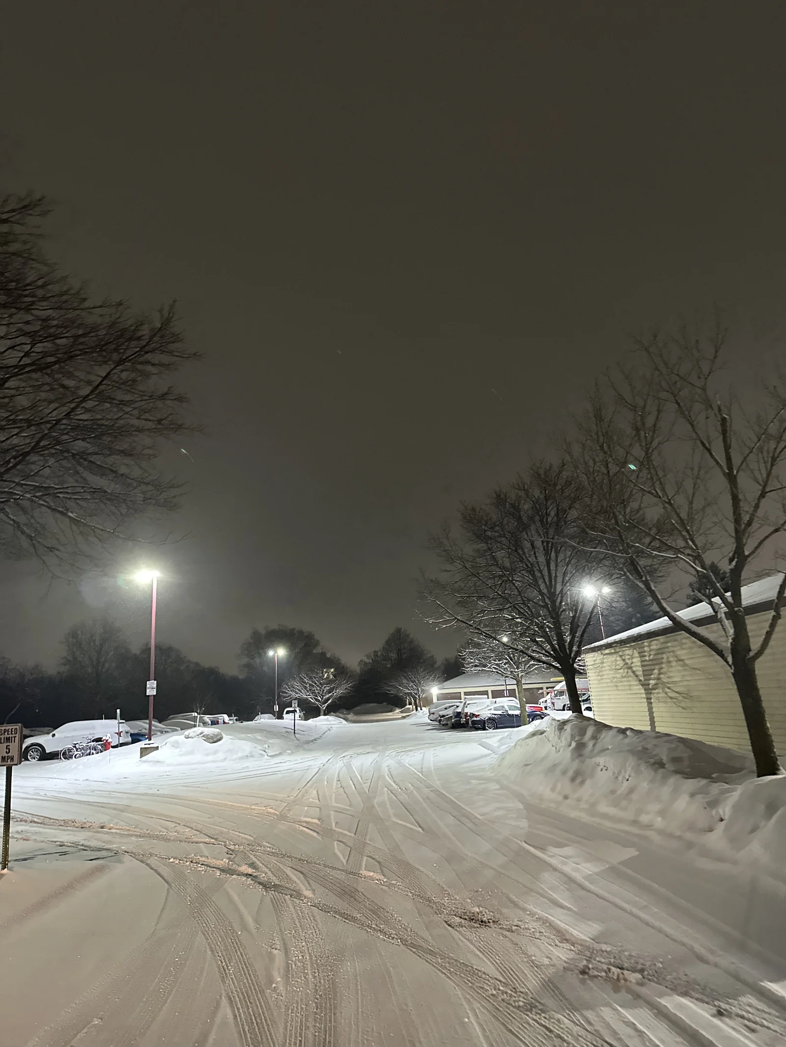 Unplowed drive lane buried in deep snow overnight at Cloverleaf Apartments in Blaine, Minnesota