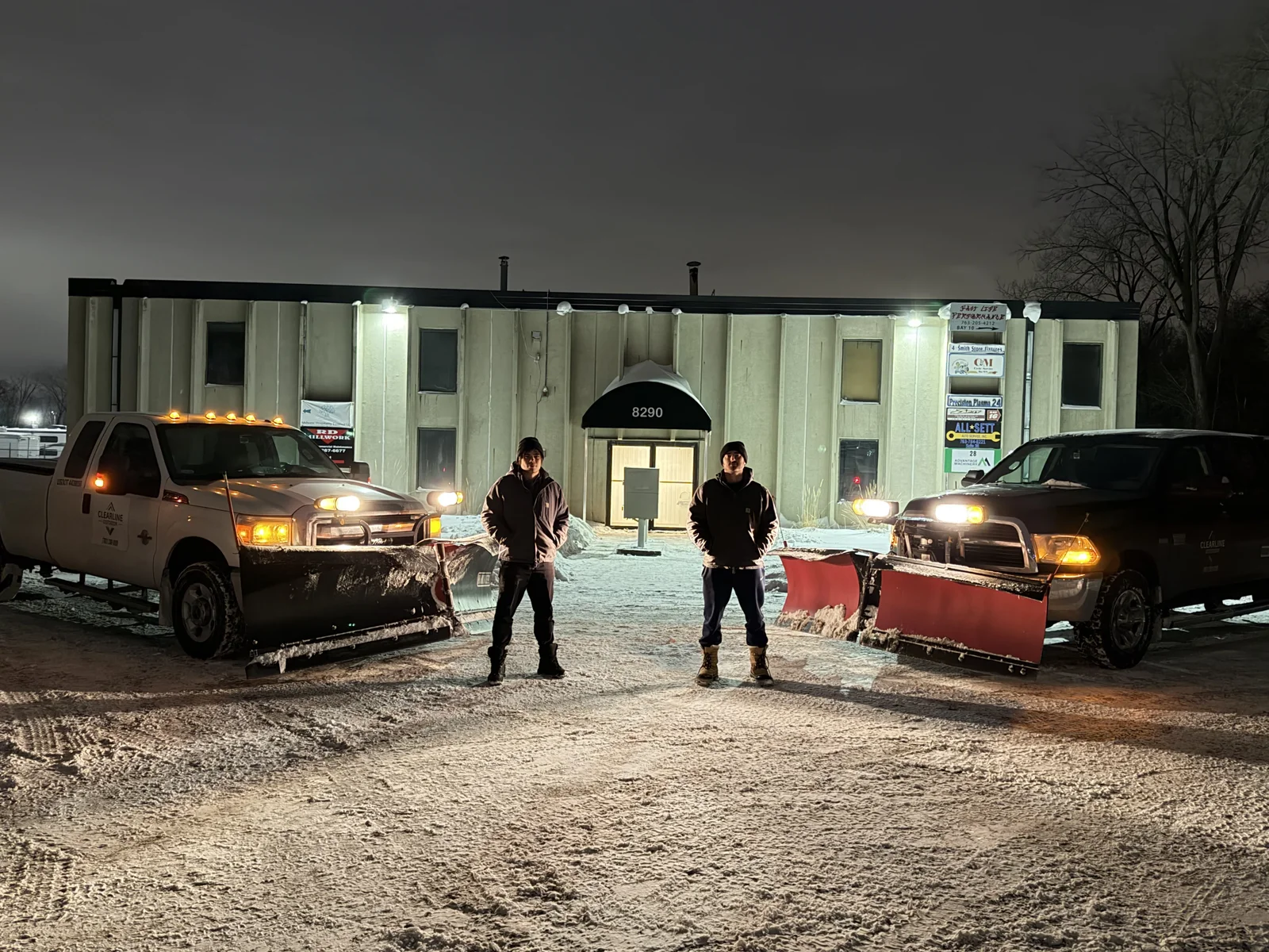Clearline Outdoor owners Carsten and Brock with plow trucks outside an industrial property in Fridley, Minnesota