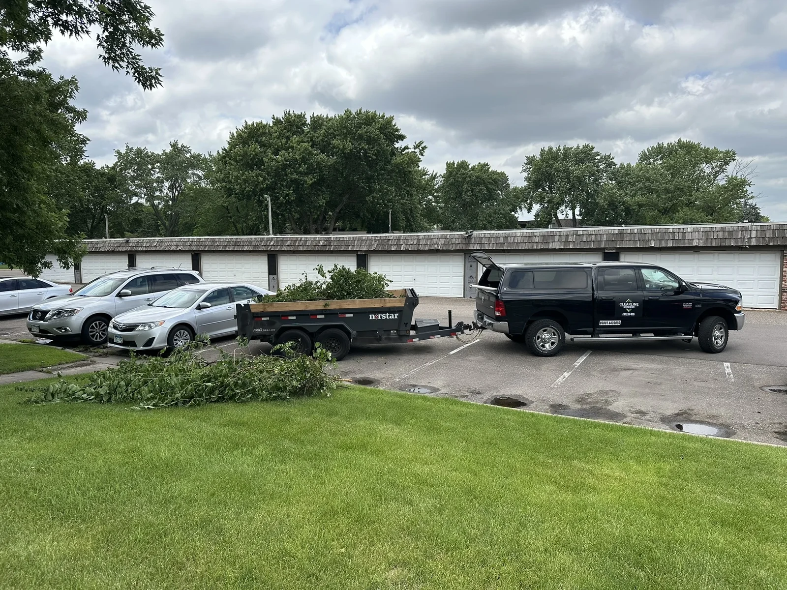 Clearline Outdoor truck and dump trailer loaded with trimmed brush at Four Seasons Villa in Plymouth, Minnesota