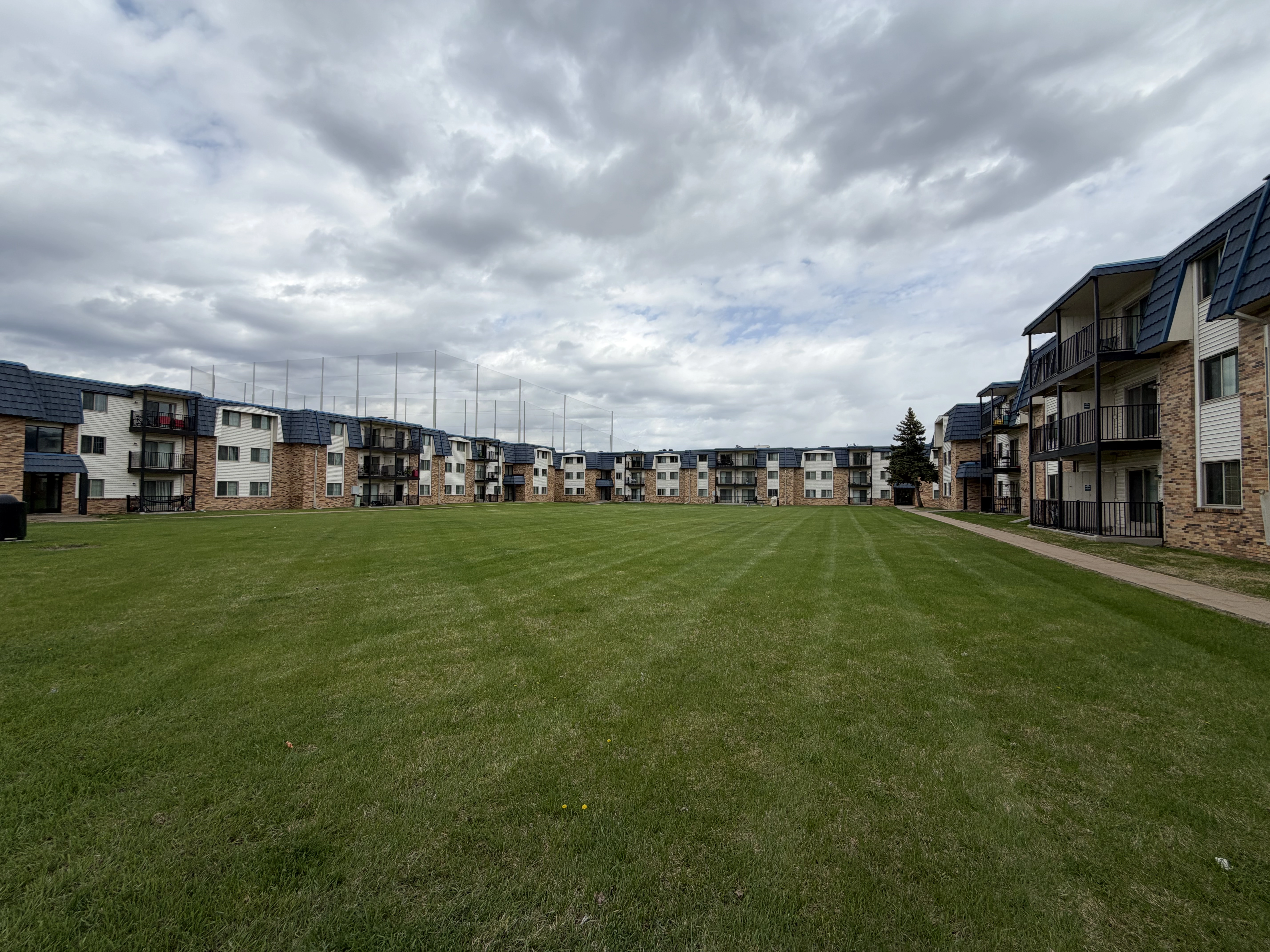 Freshly mowed courtyard grounds at Melrose Gates Apartments in Brooklyn Center, Minnesota